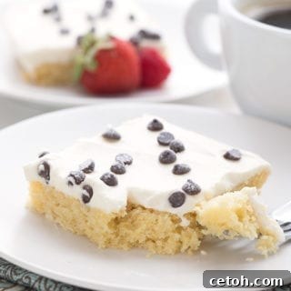 Keto Cannoli Dream Cake 5 Close up shot of cannoli sheet cake with a forkful taken out.