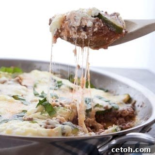 A scoopful of keto skillet lasagna being pulled away from the skillet