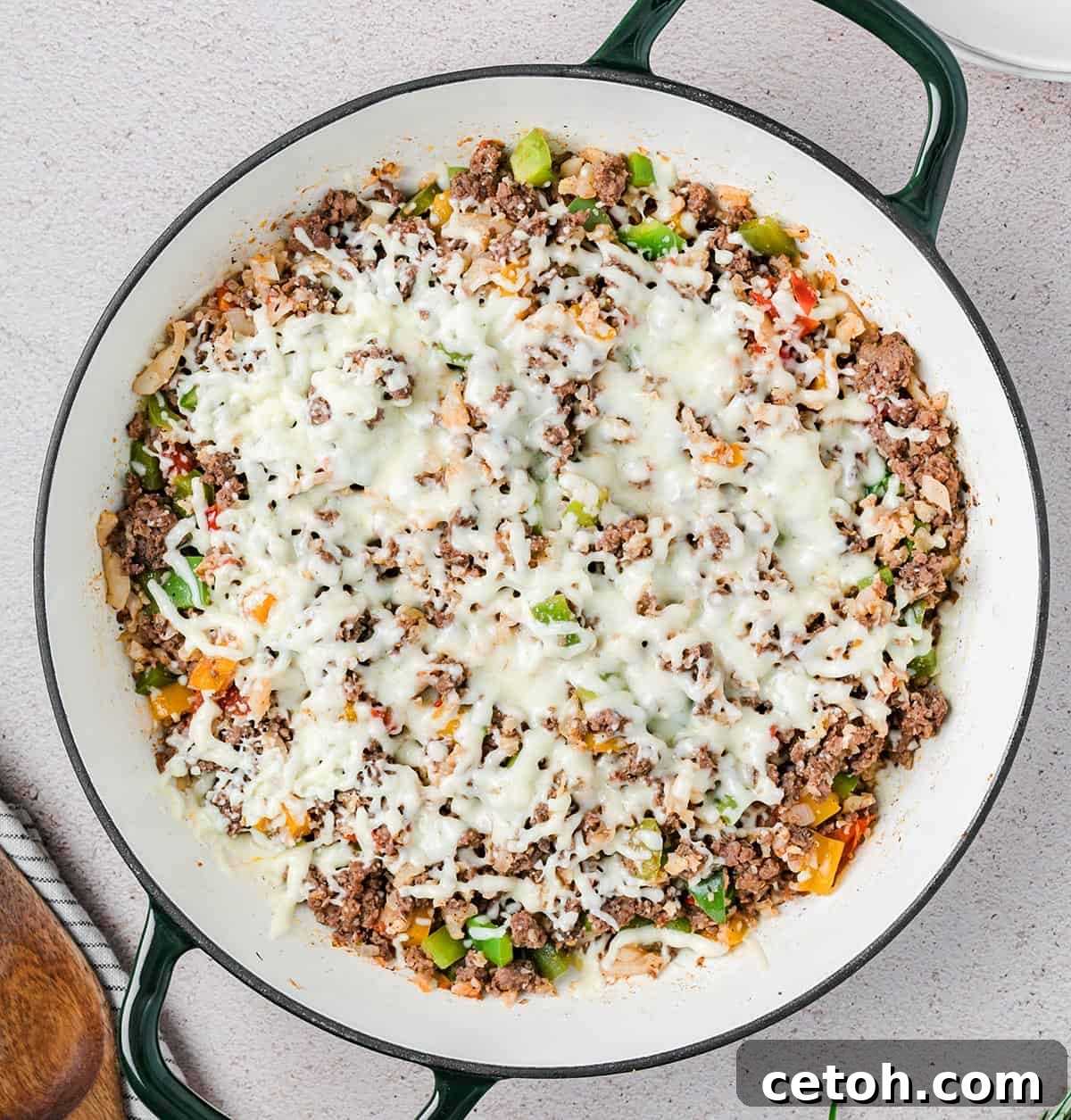 Top down image of Keto Stuffed Pepper Skillet in a large enameled pan with two handles.