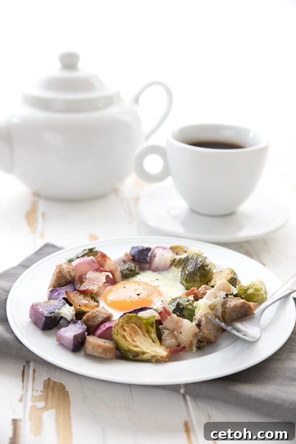 Sheet Pan Keto Morning Delight 4 A serving of sheet pan breakfast on a white plate with coffee in the background
