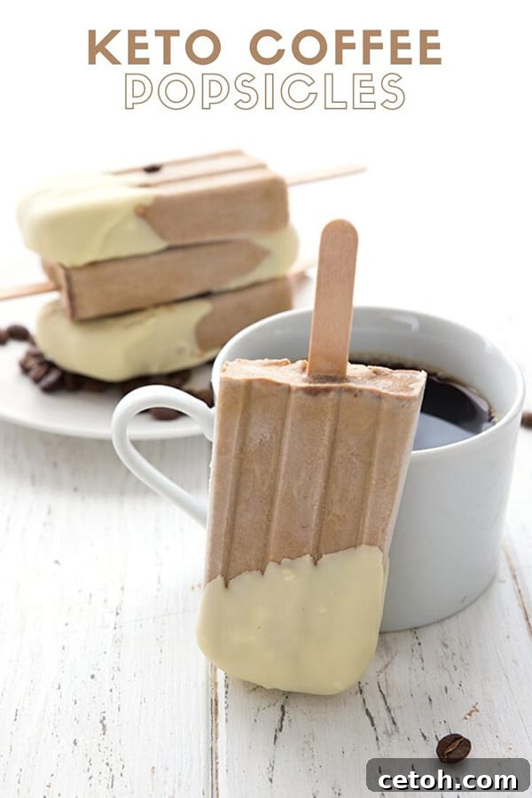 Frozen Keto Coffee Delights 2 Titled image of creamy keto coffee popsicles on a white table, with one popsicle leaning against a cup of black coffee, surrounded by scattered coffee beans.
