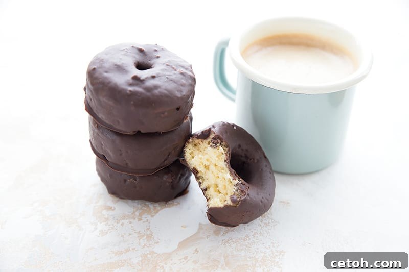 Irresistible Keto Chocolate Minis 4 A cup of coffee with a stack of mini keto donuts.