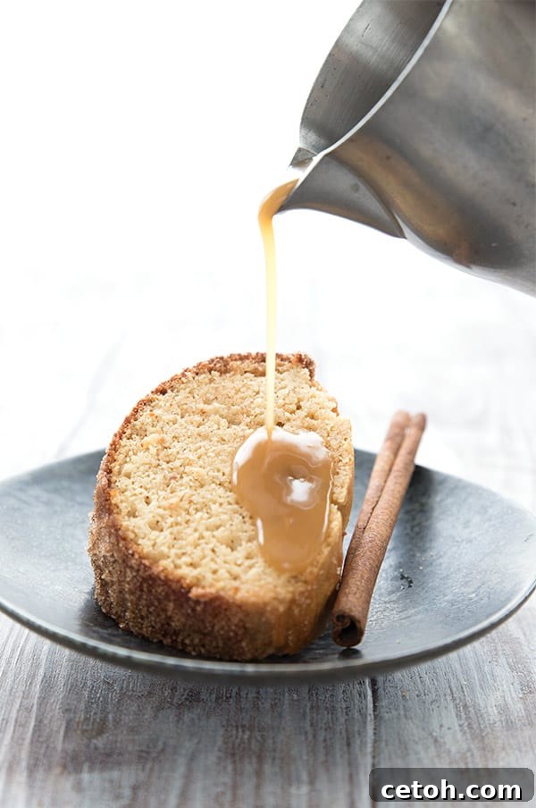 Sugar-free caramel sauce being poured generously over a tempting slice of keto apple cake, creating a luxurious low-carb dessert.