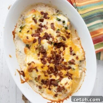 Loaded Jalapeno Popper Chicken 2 Top down image of Jalapeño Popper Chicken in a ceramic oval baking dish.