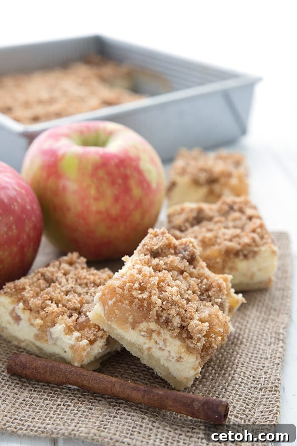 Keto apple pie bars on a burlap napkin over a white table.