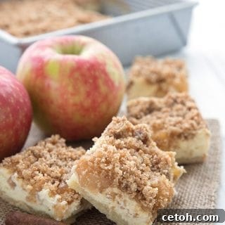 Keto apple pie bars on a burlap napkin over a white table.