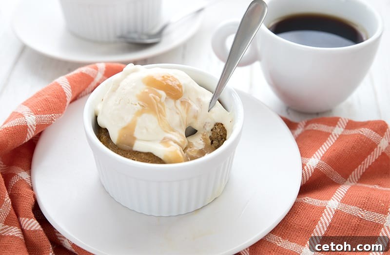 Keto vanilla ice cream melting on a pumpkin lava cake, with caramel sauce drizzled over, creating an irresistible dessert.