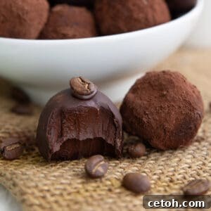 Close up shot of two keto truffles on a piece of burlap with a bite taken out of one of them.