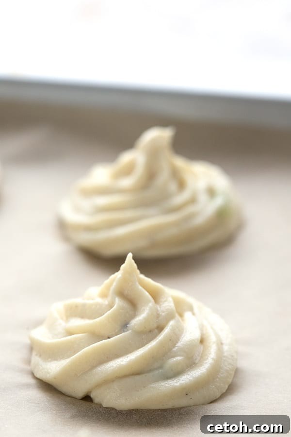 Keto Duchess Whipped Swirls 4 Keto mashed cauliflower piped onto parchment paper into beautiful swirls