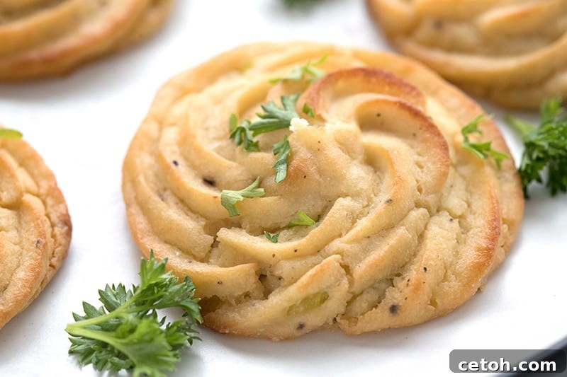 Keto Duchess Whipped Swirls 6 Close up shot of keto duchess cauliflower on a white plate with parsley