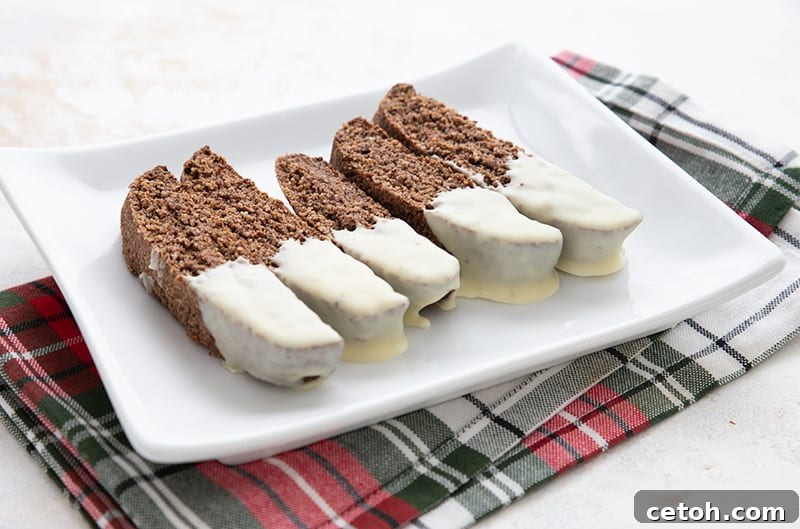 A white platter filled with low carb gingerbread biscotti over a plaid Christmas napkin.