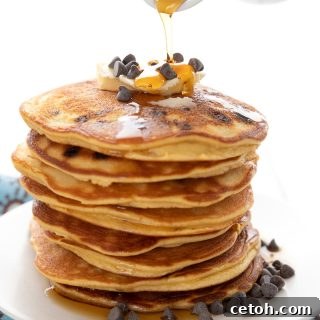Sugar-free syrup being poured over a stack of keto pancakes