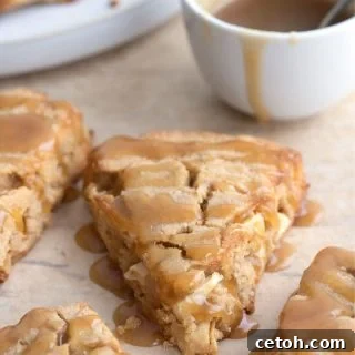 Titled image of Keto Caramel Apple Scones on brown parchment paper with a bowl of sugar free caramel sauce.