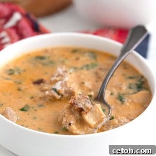 Titled image of a bowl of Keto Tuscan Chicken Soup with a spoon in it.