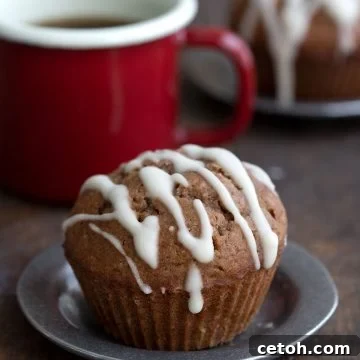 Cozy Keto Gingerbread Muffins 2 Close up shot of a keto gingerbread muffin with a cup of coffee in the background.