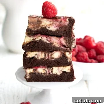 A stack of Keto Cheesecake Brownies on a white cupcake stand.