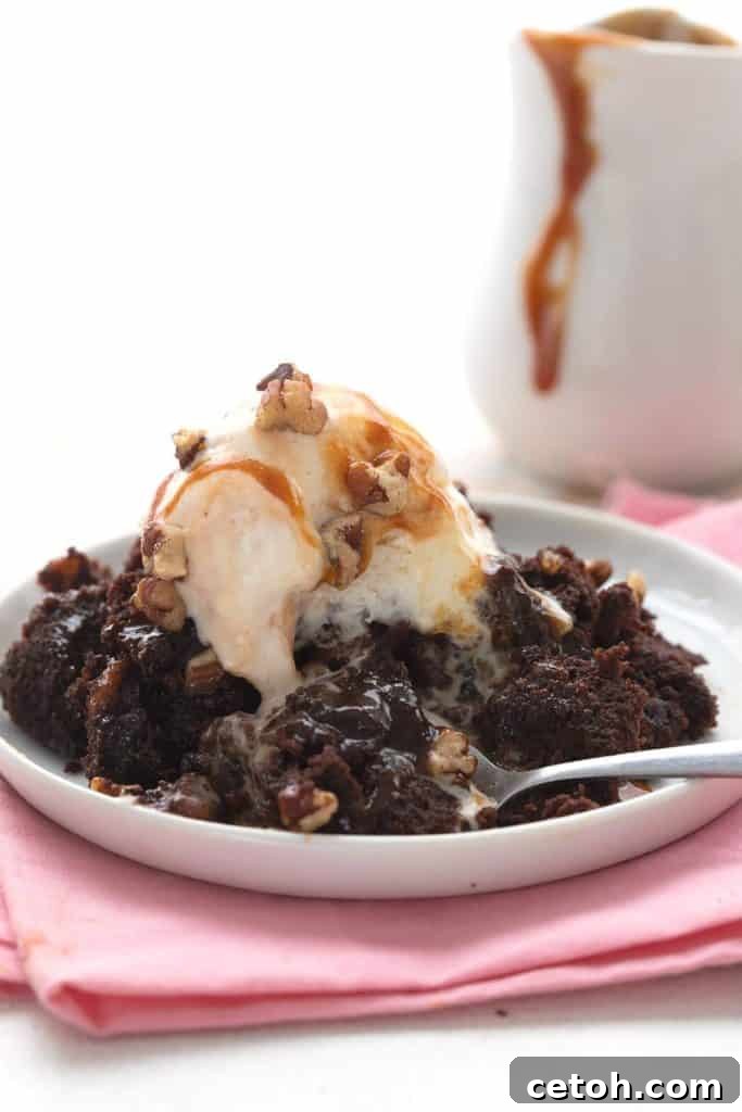 Gooey keto slow cooker brownies on a white plate over a pink napkin.