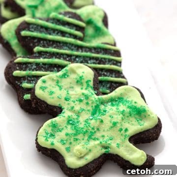 Keto shamrock shaped cookies on a white platter.