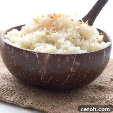 Tropical Coconut Cauliflower Rice 2 A brown wooden bowl filled with coconut cauliflower rice over a burlap napkin.