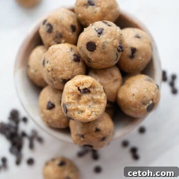 Top down image of a pile of keto peanut butter protein balls with a bite taken out of one.