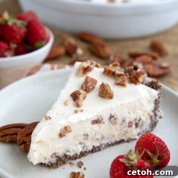 Keto Butter Pecan Ice Cream Pie on a white plate with strawberries.