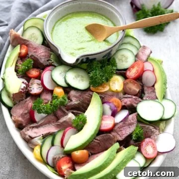 Chimichurri Steak Salad arranged on a large oval platter.