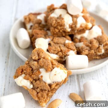 A Keto Fluffernutter Bar in front of a plate of more bars.