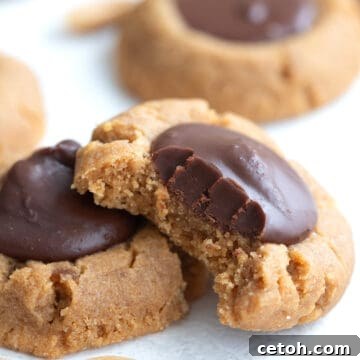 Close up shot of a Keto Peanut Blossoms with a bite taken out of it.