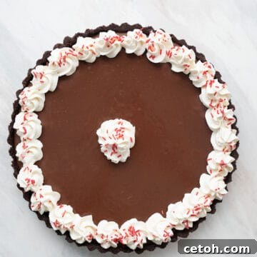 Top down image of Keto Chocolate Peppermint Tart on a marble tabletop.