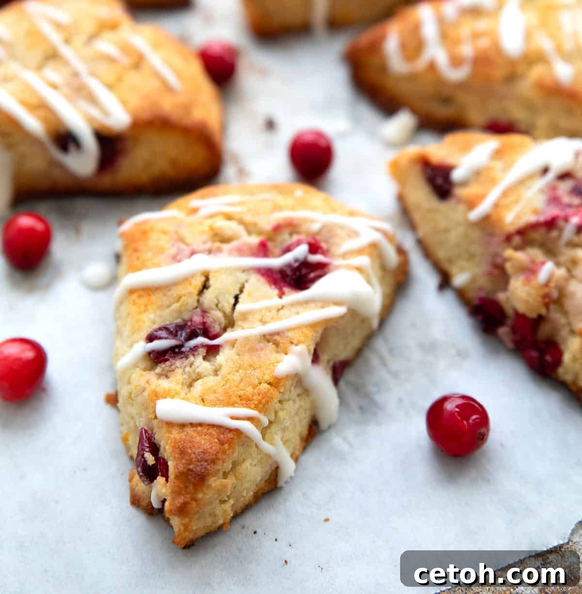 Zesty Keto Cranberry Orange Loaf 4 Freshly baked Keto Cranberry Orange Scones on a baking sheet, ready to be enjoyed.