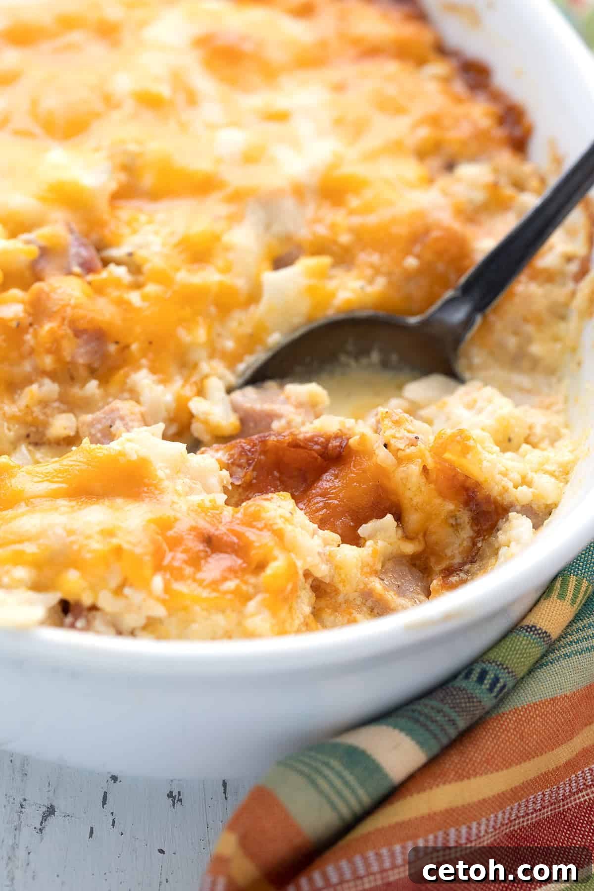 Fragrant Moroccan Lamb Stew 4 Close up shot of keto cauliflower casserole in a white dish with a serving spoon, bubbling hot.