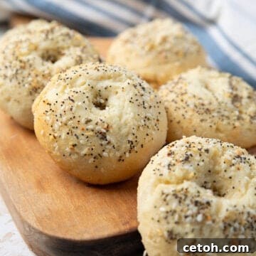 Cottage cheese protein bagels arranged on a wooden cutting board.