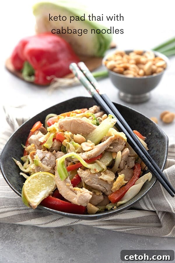 Titled image of keto pad thai in a black bowl with chopsticks.