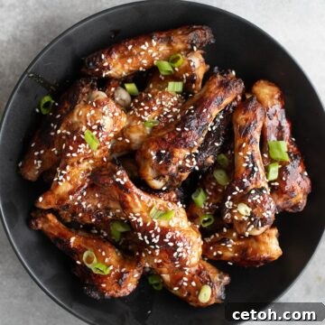 Top down image of a black bowl filled with Keto Teriyaki Chicken Wings.