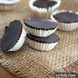 A close-up of a stack of chocolate coconut cups, emphasizing their rich texture.