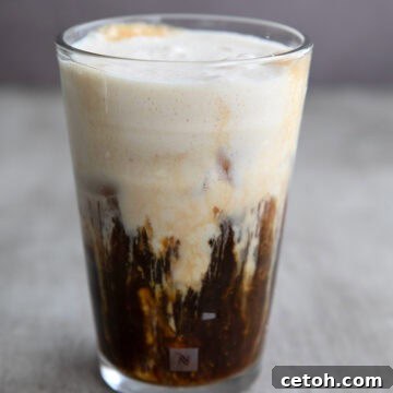 A glass of Iced Protein Coffee in a gray concrete table.