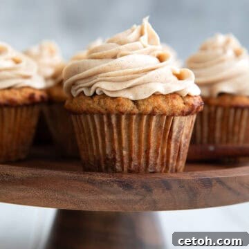 Keto Spice Cake Cupcake on a wooden cake stand.