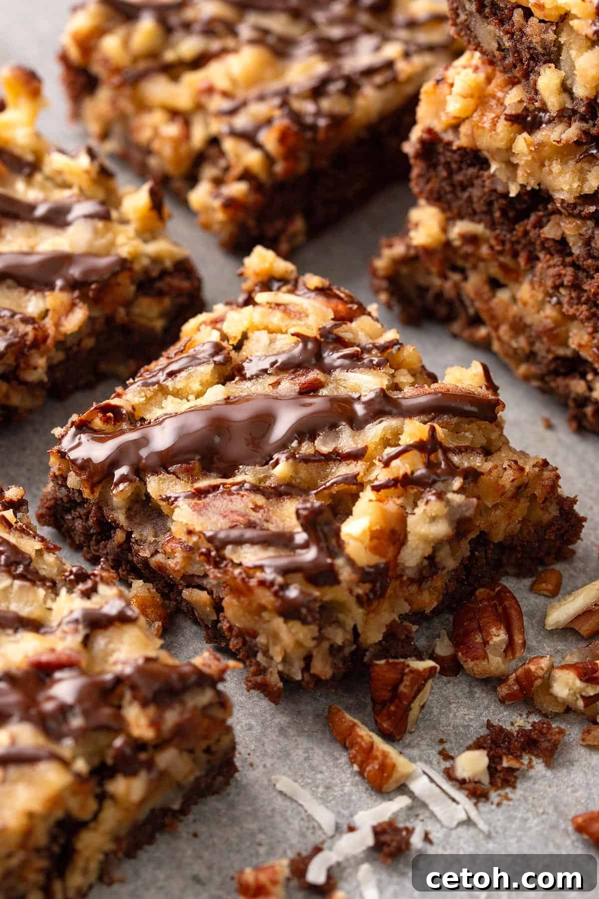 Delectable German chocolate brownies surrounded by a generous scattering of chopped pecans and shredded coconut.