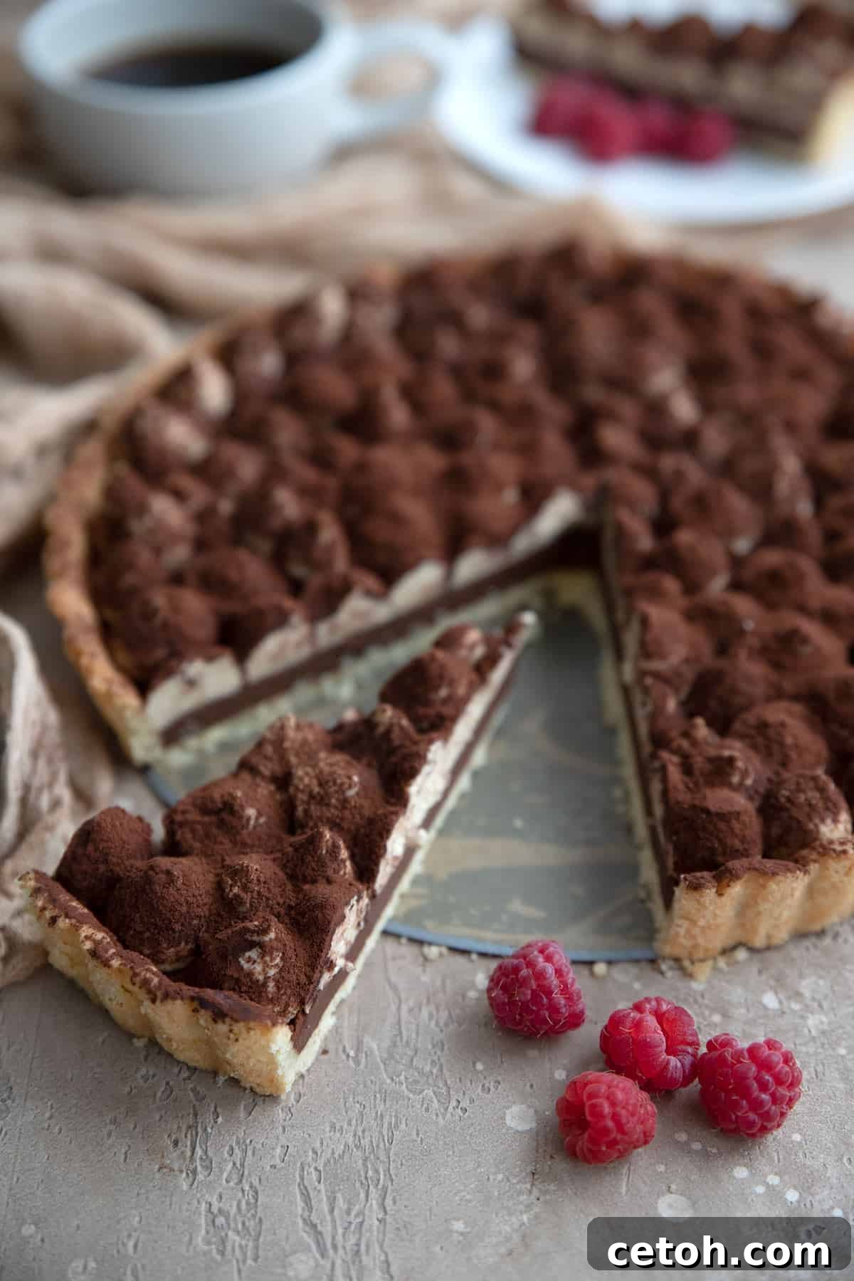 Decadent Keto Butter Tarts 3 An inviting slice of Keto Tiramisu Tart, revealing its distinct layers of coffee-infused crust, rich ganache, and creamy mascarpone.