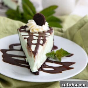 A slice of Keto Grasshopper Pie on a white plate with sugar free chocolate sauce.