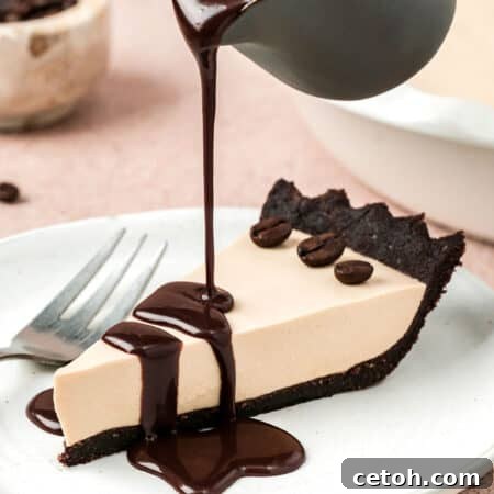 A small pot pouring chocolate sauce over a slice of Keto Cold Brew Coffee Pie.