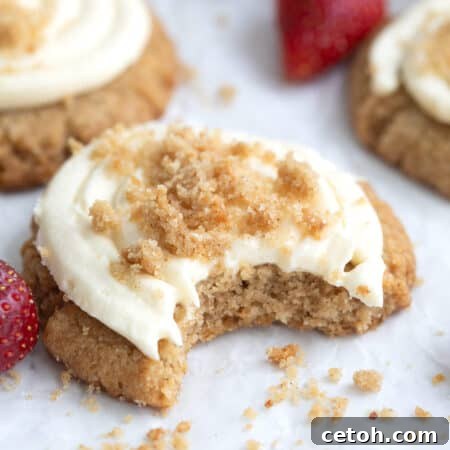 Close up shot of a keto cheesecake cookie with a bite taken out of it.