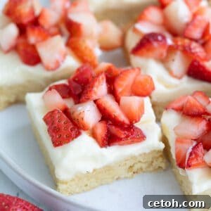 Close up shot of Keto Strawberry Shortcake Bars on a white plate.