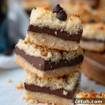 Close up shot of a stack of Keto Fudge Crumb Bars on a white table.
