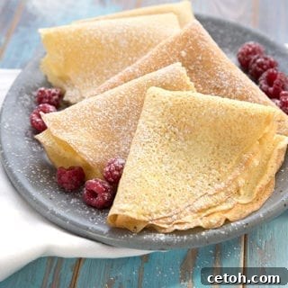 Keto crepes on a grey plate with a white napkin.