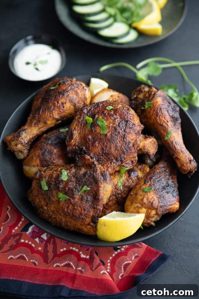 Low-Carb Keto Granola Recipe for Air Fryer (Crunchy & Fast) 11 A black bowl filled with Air Fryer Tandoori Chicken on a black tabletop, with a red patterned napkin.
