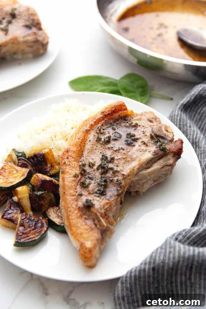 Low-Carb Keto Granola Recipe for Air Fryer (Crunchy & Fast) 13 An air fryer pork chop with a side of cauliflower rice and sautéed zucchini on a white plate.